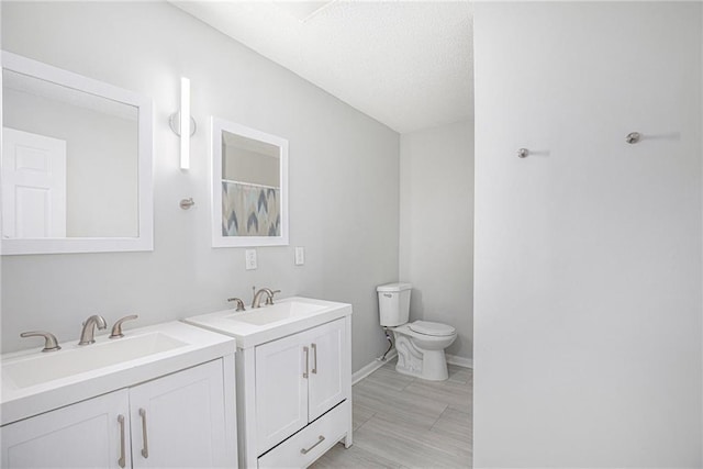 4937 Highland Ave, Kansas City, MO 64110 - bathroom featuring toilet and two vanities