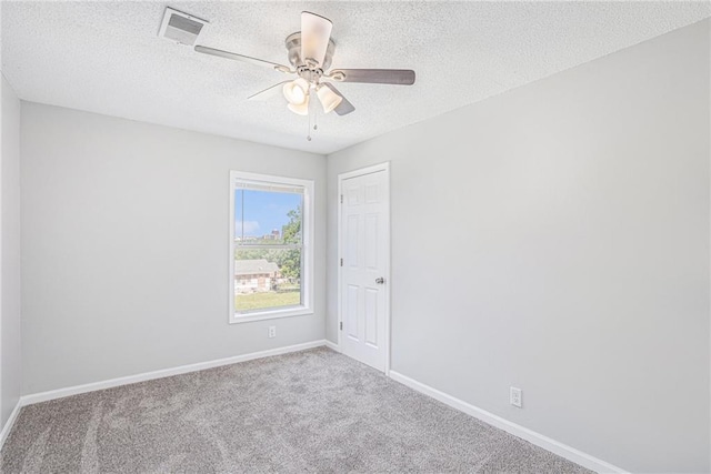 4937 Highland Ave, Kansas City, MO 64110 - unfurnished room with a textured ceiling, carpet, and ceiling fan
