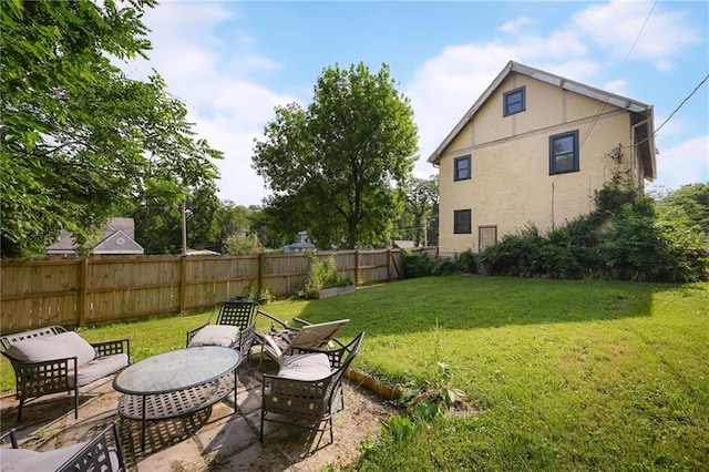 5024 Woodland Ave, Kansas City, MO 64110 - fenced backyard featuring a patio area