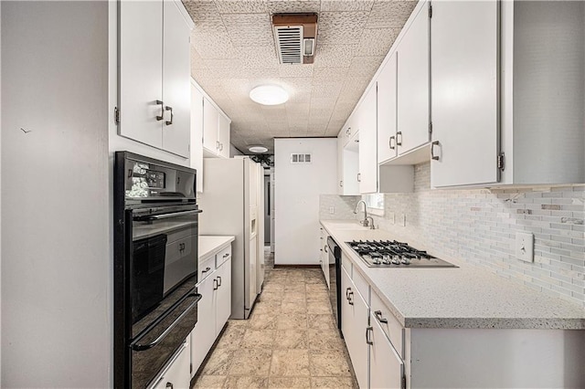 5919 N Adrian Ter, Kansas City, MO 64152 - kitchen featuring stainless steel gas cooktop, black oven, a warming drawer, and backsplash