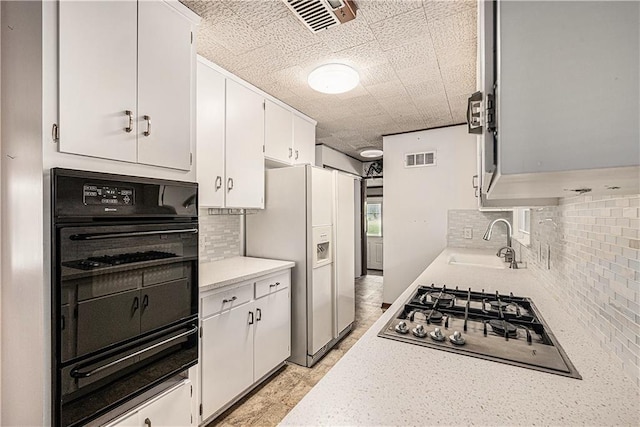 5919 N Adrian Ter, Kansas City, MO 64152 - kitchen with oven, a warming drawer, stainless steel gas cooktop, light countertops, and tasteful backsplash