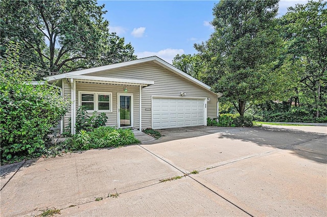 5919 N Adrian Ter, Kansas City, MO 64152 - view of front facade with concrete driveway and a garage