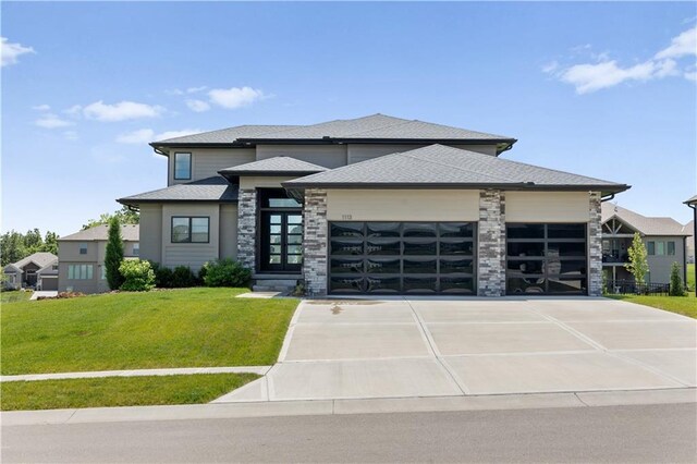 1113 Hummingbird Ct, Greenwood, MO 64034 - prairie-style house featuring a garage, a front yard, driveway, and stone siding