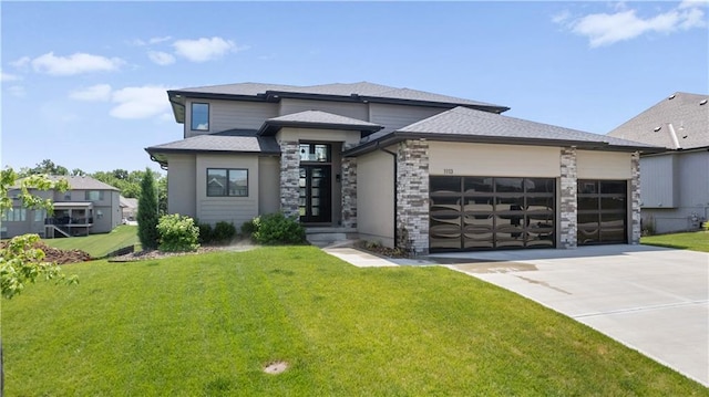 1113 Hummingbird Ct, Greenwood, MO 64034 - prairie-style home featuring a garage, a front yard, driveway, stone siding, and a shingled roof