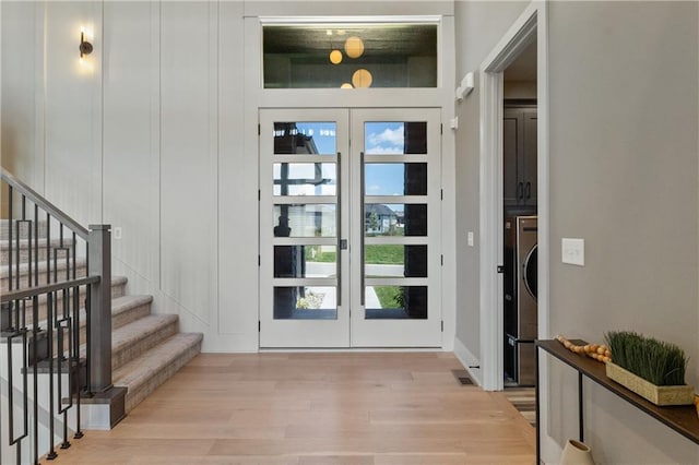 1113 Hummingbird Ct, Greenwood, MO 64034 - foyer featuring french doors, light wood-style flooring, and stairs