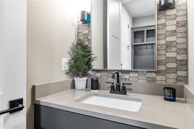 1113 Hummingbird Ct, Greenwood, MO 64034 - bathroom with vanity and tasteful backsplash