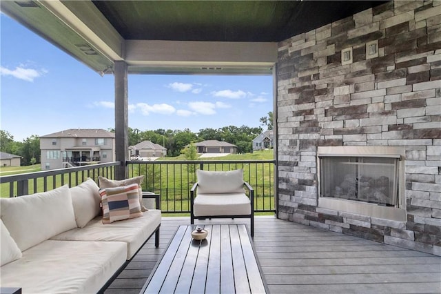1113 Hummingbird Ct, Greenwood, MO 64034 - wooden deck featuring an outdoor living space with a fireplace and a residential view
