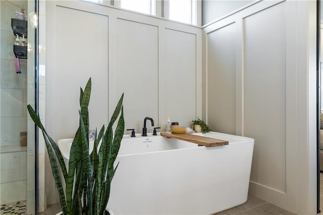 1113 Hummingbird Ct, Greenwood, MO 64034 - bathroom with a soaking tub, tile patterned flooring, and tiled shower