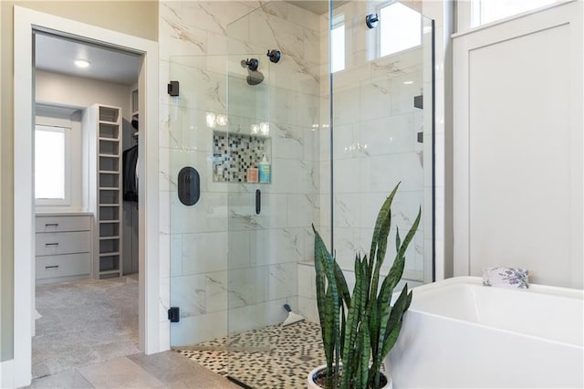 1113 Hummingbird Ct, Greenwood, MO 64034 - bathroom with a stall shower, a spacious closet, and a bath