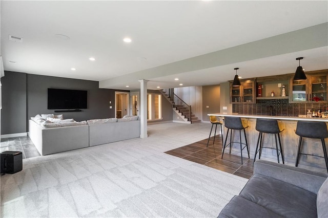 1113 Hummingbird Ct, Greenwood, MO 64034 - living room with wet bar, recessed lighting, stairs, and light colored carpet
