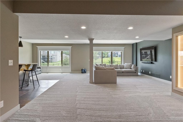 1113 Hummingbird Ct, Greenwood, MO 64034 - living area with carpet flooring, recessed lighting, and a textured ceiling