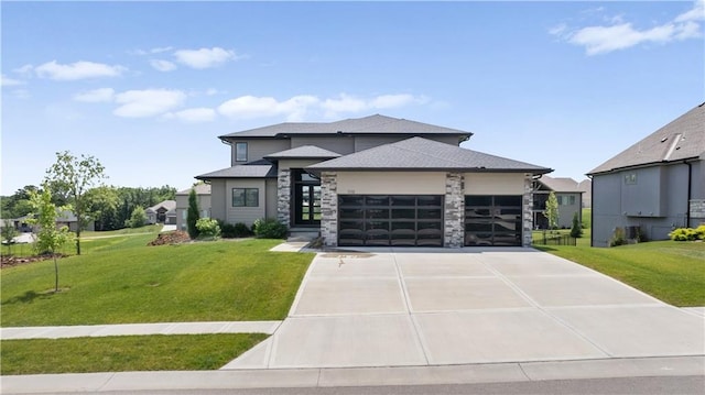 1113 Hummingbird Ct, Greenwood, MO 64034 - prairie-style house featuring a garage, concrete driveway, a front yard, stone siding, and roof with shingles