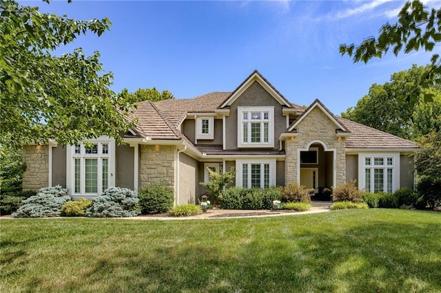 1021 SW Summit Falls Dr, Lees Summit, MO 64081 - view of front facade featuring stone siding, stucco siding, and a front lawn