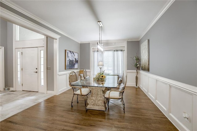 1021 SW Summit Falls Dr, Lees Summit, MO 64081 - dining area with crown molding, a decorative wall, dark wood finished floors, and wainscoting