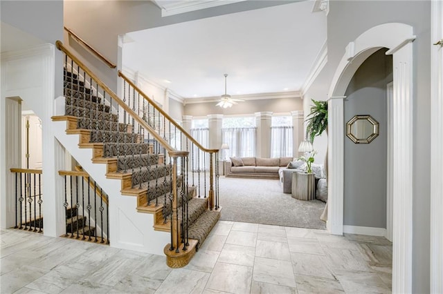 1021 SW Summit Falls Dr, Lees Summit, MO 64081 - foyer featuring a ceiling fan, crown molding, stairs, arched walkways, and ornate columns