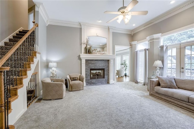 1021 SW Summit Falls Dr, Lees Summit, MO 64081 - carpeted living area with a fireplace, crown molding, ceiling fan, french doors, and stairway