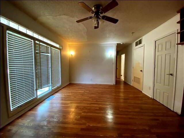 4738 Norton Cir, Kansas City, MO 64128 - spare room featuring ceiling fan and wood finished floors