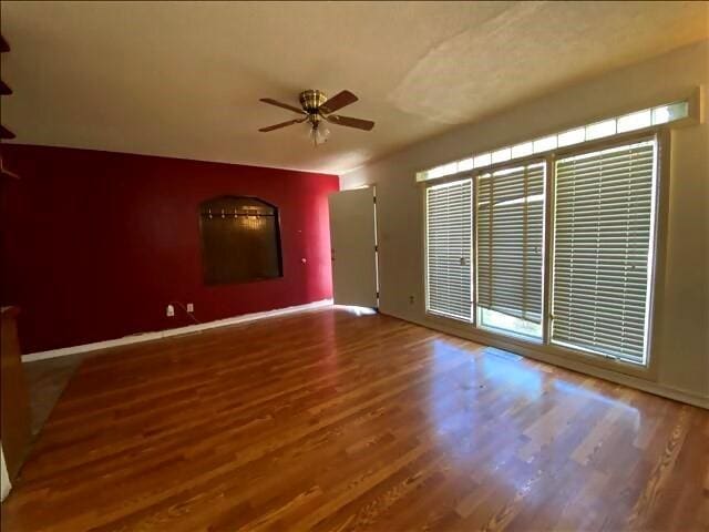 4738 Norton Cir, Kansas City, MO 64128 - unfurnished room with a ceiling fan and wood finished floors