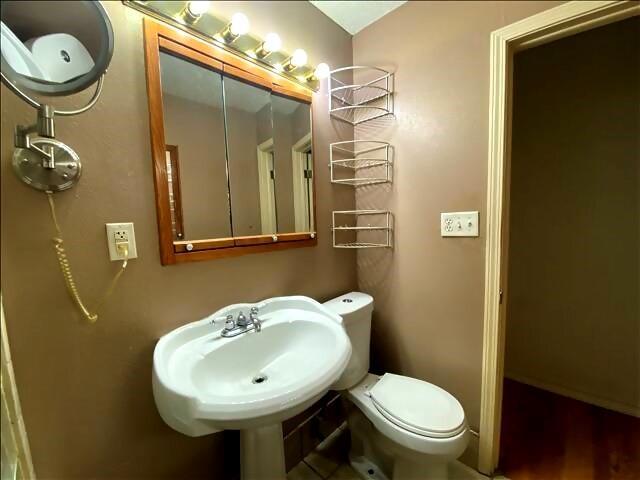 4738 Norton Cir, Kansas City, MO 64128 - bathroom featuring toilet and a sink