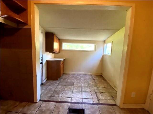 4738 Norton Cir, Kansas City, MO 64128 - laundry room with light tile patterned floors