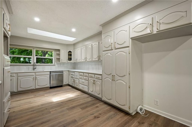 2415 E 126th St, Kansas City, MO 64146 - kitchen with dishwasher, wood finished floors, a skylight, open shelves, and decorative backsplash