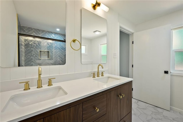 2415 E 126th St, Kansas City, MO 64146 - full bathroom with double vanity, marble finish floors, and a shower with shower door