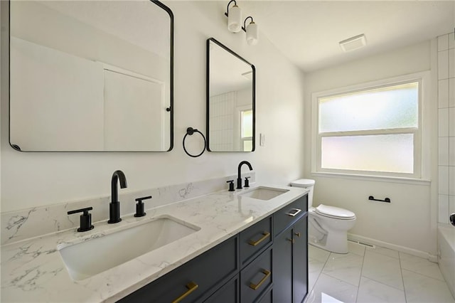 2415 E 126th St, Kansas City, MO 64146 - bathroom with marble look tiles, double vanity, and tub / shower combination