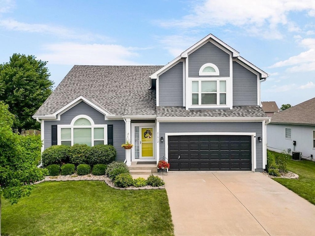 1912 Sequoia Dr, Raymore, MO 64083 - view of front of home featuring an attached garage, a front yard, concrete driveway, and roof with shingles