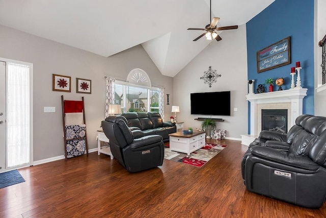 1912 Sequoia Dr, Raymore, MO 64083 - living area featuring high vaulted ceiling, wood finished floors, ceiling fan, and a tile fireplace