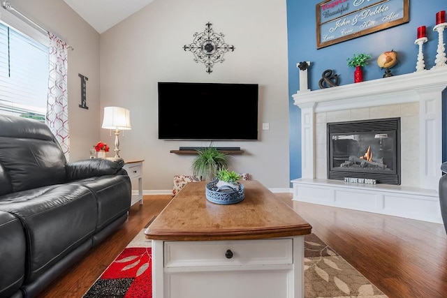 1912 Sequoia Dr, Raymore, MO 64083 - living room with dark wood-style flooring, a tile fireplace, and lofted ceiling