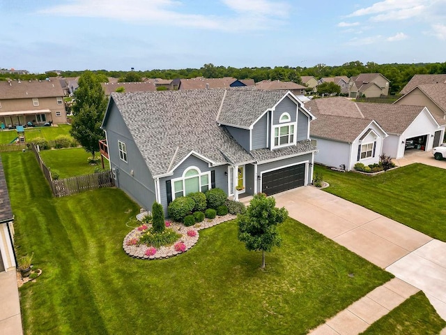 1912 Sequoia Dr, Raymore, MO 64083 - traditional-style home with a garage, driveway, and a residential view