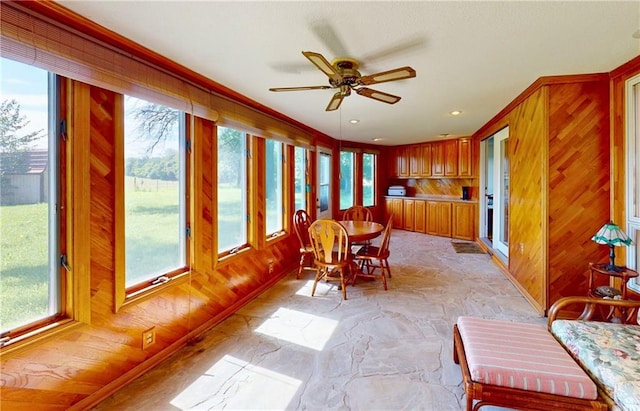 4598 N Avilla St, Reeds, MO 64859 - sunroom featuring healthy amount of natural light, stone flooring, and wood walls
