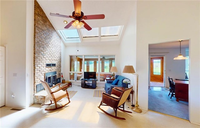 4598 N Avilla St, Reeds, MO 64859 - carpeted living room featuring ceiling fan, high vaulted ceiling, a brick fireplace, and a skylight