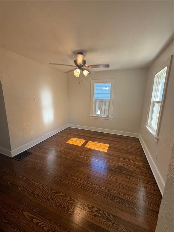 2010 N 2nd St, Saint Joseph, MO 64505 - unfurnished room with plenty of natural light, dark wood-style flooring, and a ceiling fan