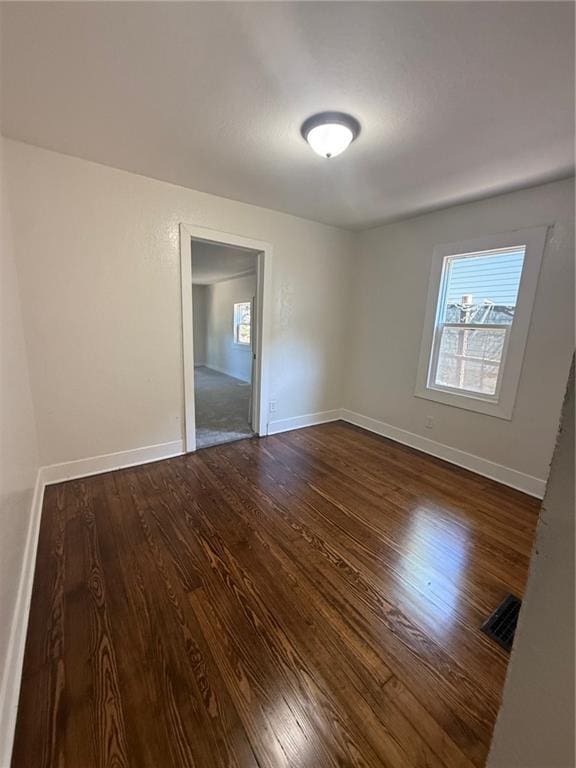 2010 N 2nd St, Saint Joseph, MO 64505 - unfurnished room with dark wood-style flooring and healthy amount of natural light