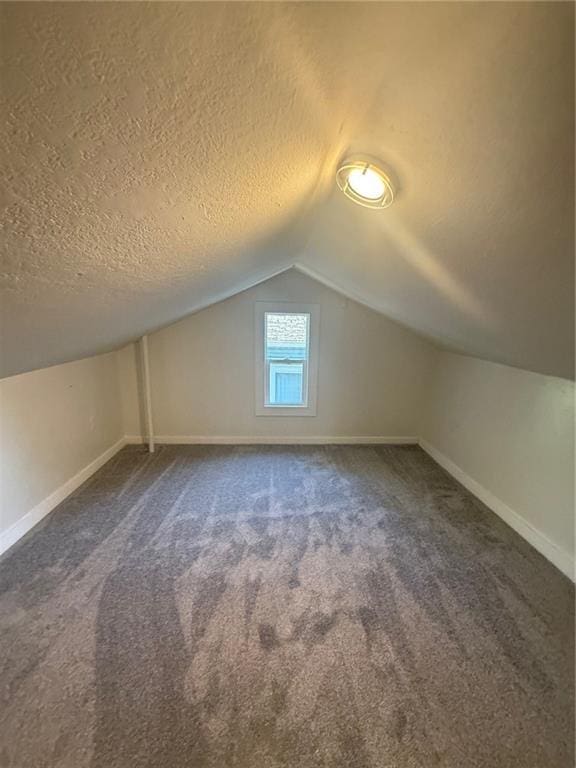 2010 N 2nd St, Saint Joseph, MO 64505 - bonus room featuring a textured ceiling, vaulted ceiling, and carpet floors