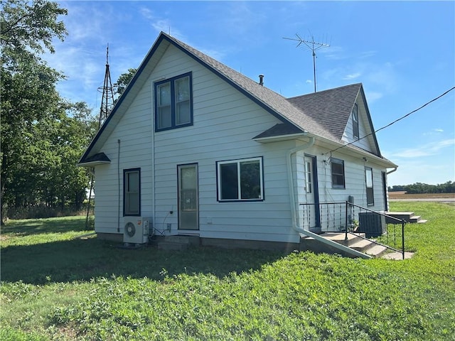 895 Cloud Rd, Salina, KS 67436 - rear view of house featuring a yard, a shingled roof, and entry steps