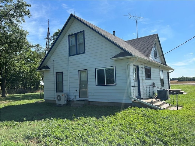 895 Cloud Rd, Salina, KS 67436 - back of house with a shingled roof, a lawn, and entry steps