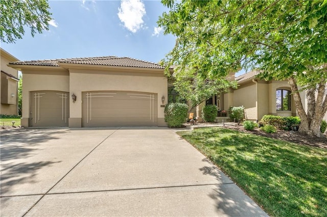 9638 Zarda Dr, Lenexa, KS 66227 - mediterranean / spanish-style home with stucco siding, an attached garage, driveway, a tile roof, and a front yard