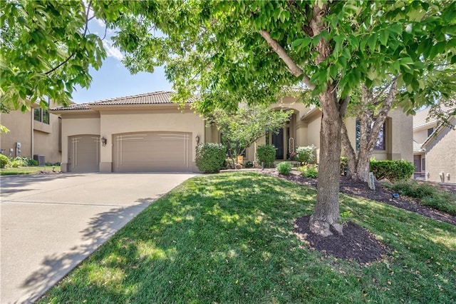 9638 Zarda Dr, Lenexa, KS 66227 - view of front of property featuring a garage, stucco siding, driveway, a tile roof, and a front yard