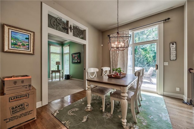 9638 Zarda Dr, Lenexa, KS 66227 - dining space with a chandelier, healthy amount of natural light, and wood finished floors