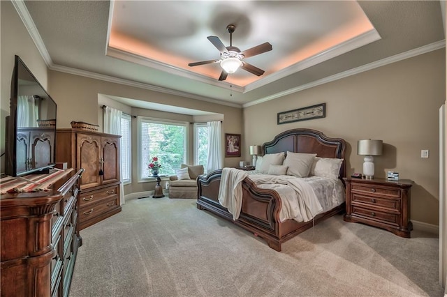 9638 Zarda Dr, Lenexa, KS 66227 - bedroom featuring a tray ceiling, carpet flooring, crown molding, and a ceiling fan