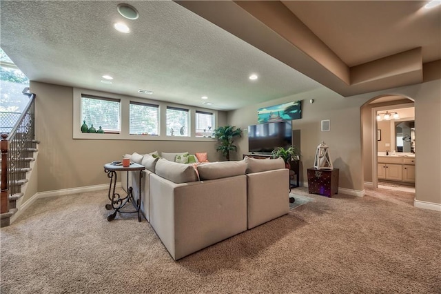 9638 Zarda Dr, Lenexa, KS 66227 - carpeted living room featuring recessed lighting, arched walkways, stairs, and a textured ceiling