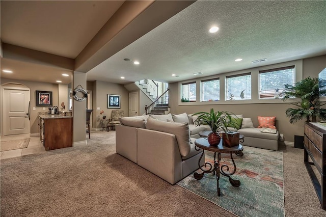 9638 Zarda Dr, Lenexa, KS 66227 - living area featuring recessed lighting, light colored carpet, stairway, a textured ceiling, and arched walkways