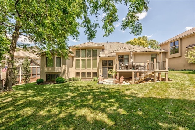 9638 Zarda Dr, Lenexa, KS 66227 - rear view of house featuring stairway, stucco siding, a yard, a tiled roof, and a wooden deck