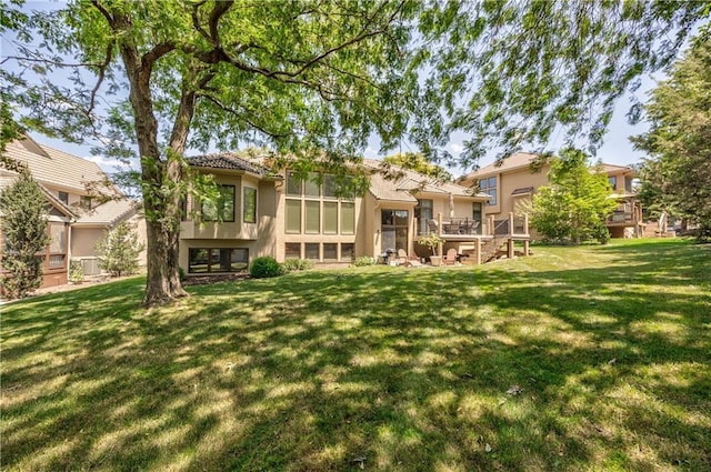 9638 Zarda Dr, Lenexa, KS 66227 - rear view of property with stucco siding, a lawn, and a wooden deck