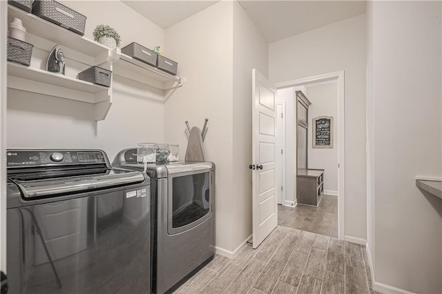 1527 SW Arbor Falls Dr, Lees Summit, MO 64082 - washroom featuring washer and clothes dryer and light wood finished floors