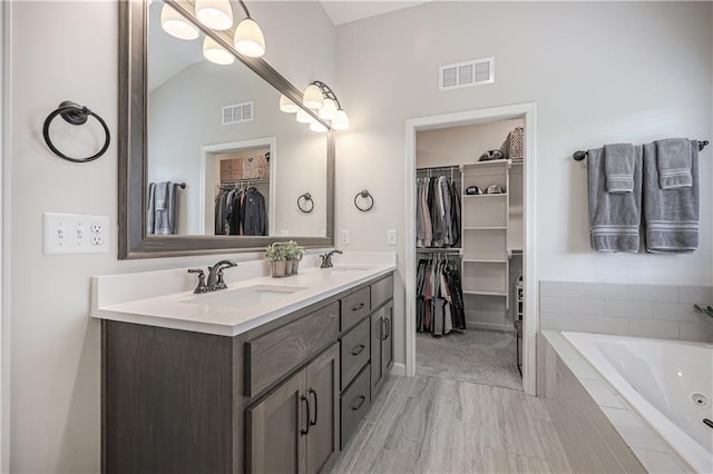 1527 SW Arbor Falls Dr, Lees Summit, MO 64082 - full bathroom with double vanity, a jetted tub, a walk in closet, and lofted ceiling