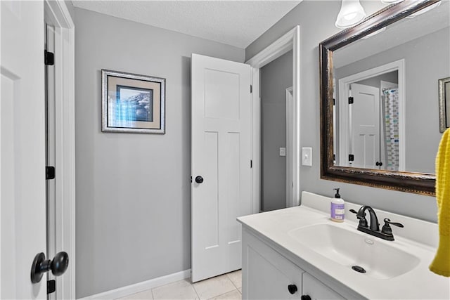 513 NE Wenonga Pl, Lees Summit, MO 64064 - bathroom featuring vanity, tile patterned flooring, and a textured ceiling