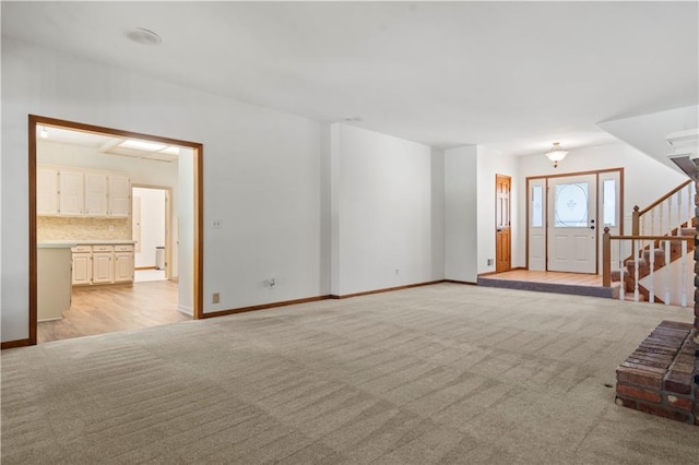 13109 W 65th St, Shawnee, KS 66216 - unfurnished living room with light carpet and stairs